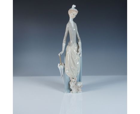 This Lladro porcelain figurine, item #1004761, portrays an elegantly dressed woman strolling with her small dog at her feet. 