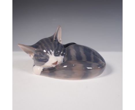 This charming porcelain figurine by Royal Copenhagen depicts a sleeping cat curled up peacefully, finished in a glossy glaze 