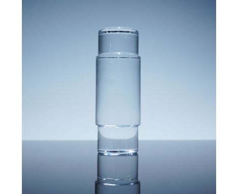 A striking Baccarat crystal obelisk paperweight, showcasing a modern geometric form. This sculptural piece features smooth cy