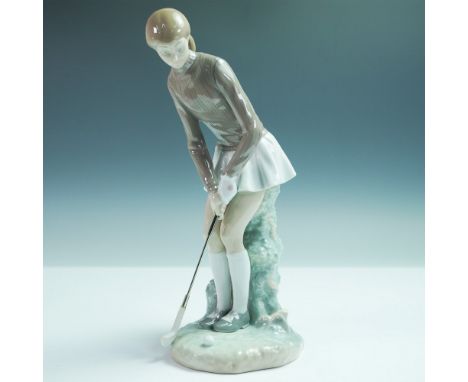 Stylish and poised, this Lladro porcelain figurine titled Lady Golfer, model number 1004851, captures the quiet focus of a go