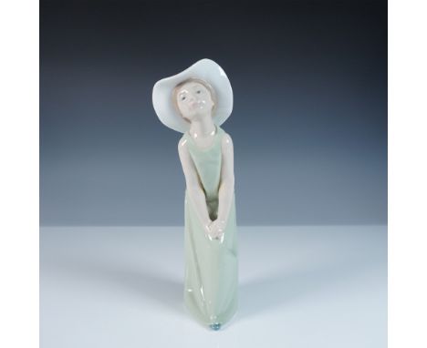 A charming Lladro porcelain figurine, Curious, model number 1005009, sculpted by Francisco Catala. This delightful piece capt