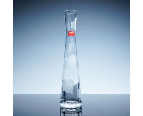 A Baccarat crystal Love vase featuring an elegant tapered silhouette adorned with frosted heart motifs. The delicate design s