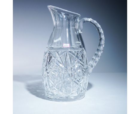 Baccarat Lagny crystal pitcher featuring geometric cuts, a fluted upper body, and faceted handle. Includes original red-borde