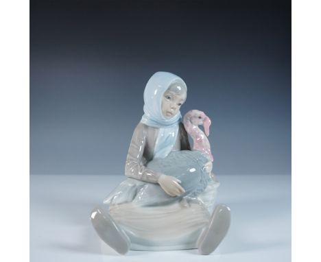 A beautifully detailed Lladro porcelain figurine, Girl with Turkey, model number 1004569, sculpted by Juan Huerta. This charm