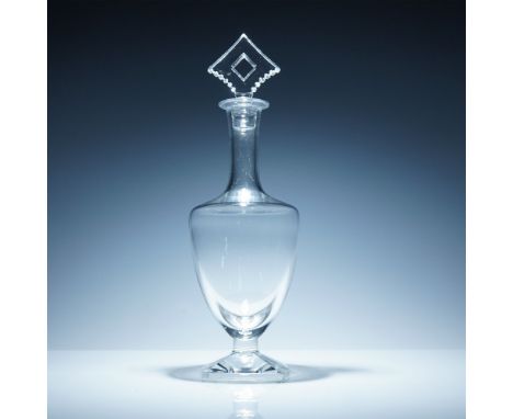 Exquisite Baccarat crystal decanter featuring a sculptural silhouette with a striking geometric diamond-shaped stopper. Craft