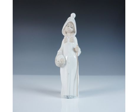 This Lladro figurine, titled Girl with Basket (#1014678), portrays a serene young girl dressed in a long hooded coat, holding