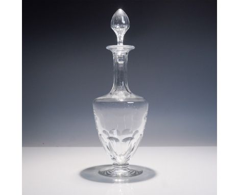A stunning Baccarat Capri crystal decanter featuring an elegant tapered form with vertical cut detailing and a faceted stoppe