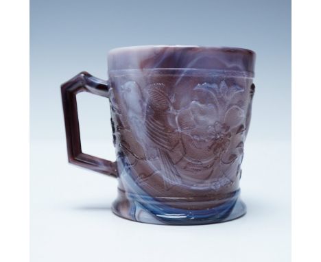 Striking slag glass mug featuring an embossed bird and floral motif, beautifully rendered in swirling hues of deep purple, wh