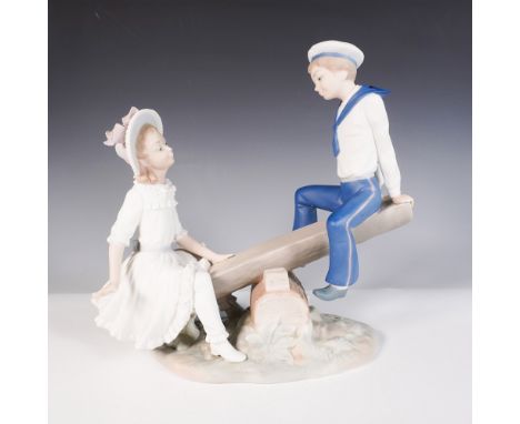 This charming matte-finish piece depicts a young boy in a sailor outfit and a girl in a bonnet playing on a seesaw. Features 