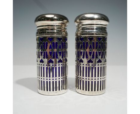 Striking 2pc salt and pepper shaker set featuring rich cobalt blue glass encased in an intricate silver filigree overlay. The