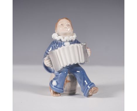 A charming Royal Copenhagen porcelain figurine, model 3667, titled Boy with Accordion. This delightful piece features a young