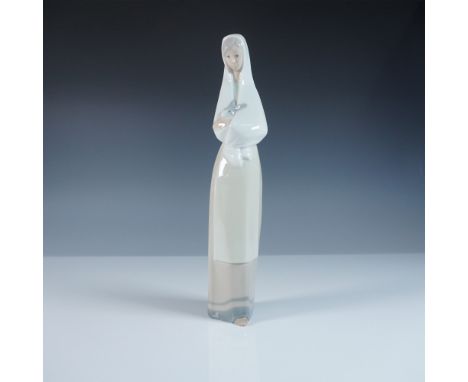 A graceful Nao by Lladro porcelain figurine depicting a serene woman cradling a small rabbit in her arms. This elegantly elon