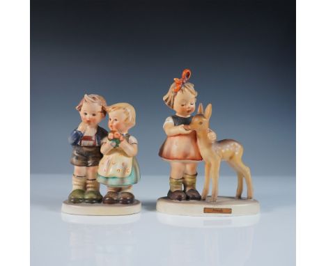 This lot includes two Goebel Hummel figurines, showcasing the beloved craftsmanship and charm of Hummel designs. The first fi