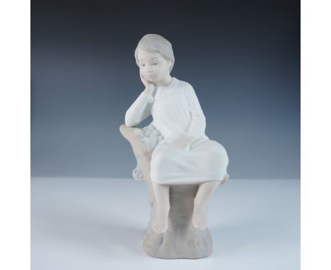 Lladro Little Boy Thinking, model 01014876, also known as Pequeno Pensador, is a contemplative porcelain figurine designed by