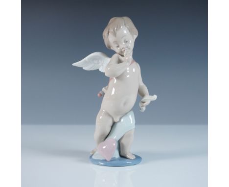 This Lladro figurine, titled Cupid (#1006311), depicts a charming cherub with delicate wings, holding a scroll and poised ato