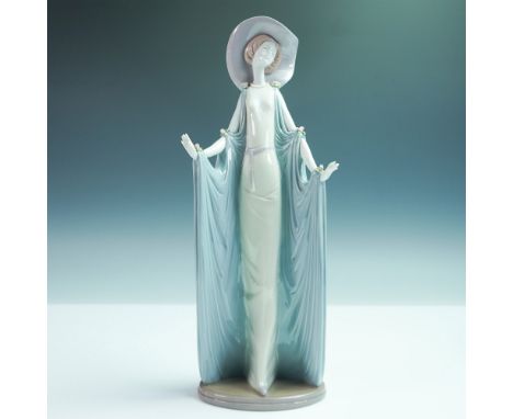 A stunning Lladro porcelain figurine titled Afternoon Tea (model 01001428), showcasing an elegantly dressed woman in a flowin