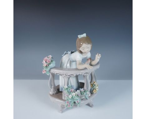 This Lladro figurine, titled Morning Song (#1006658), portrays a charming young girl leaning over an ornate balcony, engaging