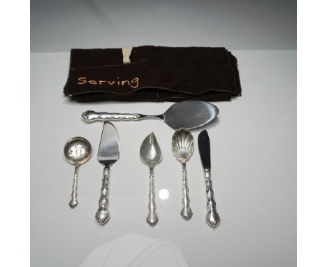 A Reed &amp; Barton serving utensil set, featuring three elegantly crafted pieces with sterling silver handles and stainless 