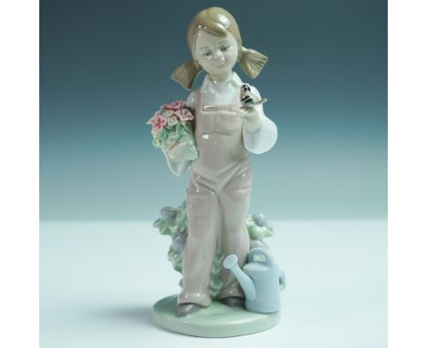 Adorable Lladro porcelain figurine titled Spring, model number 1005217. Sculpted by Juan Huerta and issued in 1984, this piec