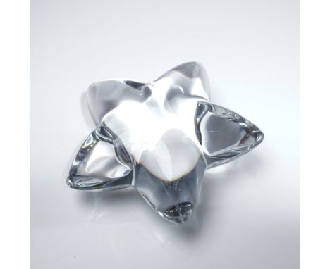 Elegant Baccarat crystal star paperweight featuring a smooth, sculptural design that reflects light beautifully. Signed with 