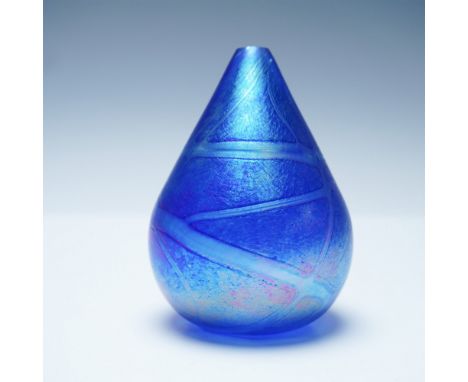 A striking iridescent blue art glass oil lamp featuring a mesmerizing opalescent shimmer. The handcrafted design showcases de