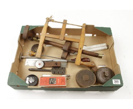 A box of tools incl bow saws, four tapes, panel gauge etc G