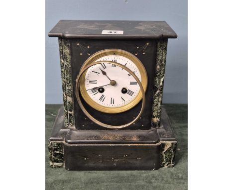 A black slate cased clock, the movement countwheel striking on a bell, the circular enamel dial between variegated green pila