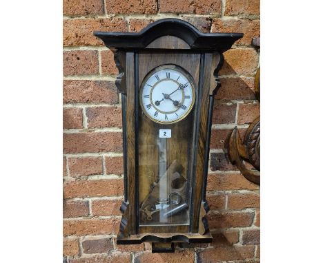 A Vienna regulator, the glazed walnut case with ebonised details, the movement striking on a coiled rod, the enamel face with