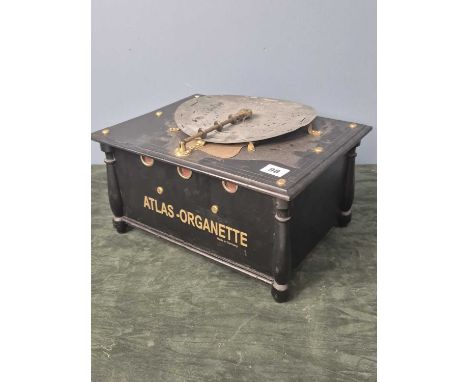 An 'Atlas-Organette' playing 22cms metal discs by turning the handle to one side