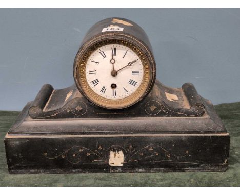 A black slate cased mantel timepiece, the circular enamel dial above flanking scrolls on the rectangular base 