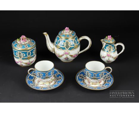 A 'Sevres' porcelain caberet service, painted with summer flower swags within a blue celeste border, comprises teapot &amp; c