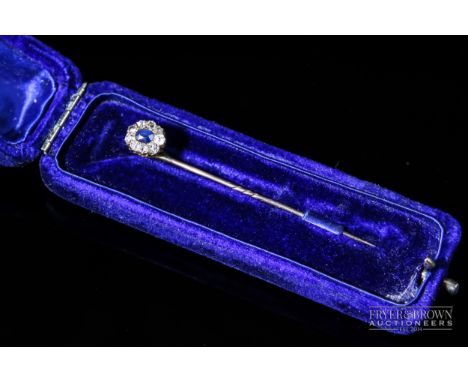 A Victorian sapphire and diamond cluster stick pin, the oval sapphire surrounded by nine old cut diamonds, in original velvet