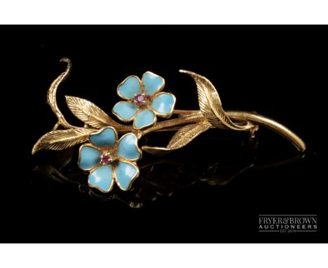 A 1960s 18 carat gold, enamel and ruby brooch, the spray composed of two turquoise enamel flowers with single ruby stamens, 7