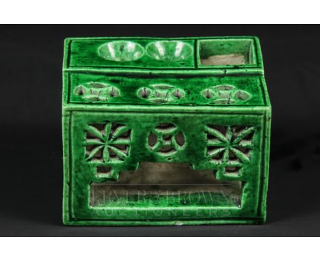 A Chinese porcelain green glaze scholars brush washer and seal stand, formed as a pierced fretwork table with two pen holders