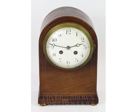 A French walnut mantel clock with enamel face, on brass bun feet, numbered 129C52