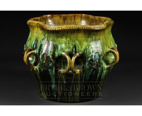 Christopher Dresser for Linthorpe (1879-89), a pottery jardiniere with foliate rim, the indented midsection applied with six 