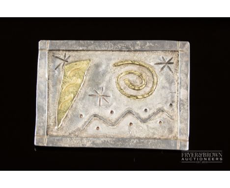 An unusual contemporary silver and gold brooch by Brion O. Casey, the rectangular planished silver plaque applied with gold a