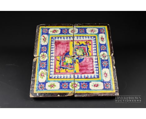 A Qajar four tile panel, brightly glaze with floral motifs within a turquoise double line border, 35cm square approx *Provena