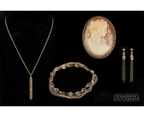 A 9 carat gold engine turned toothpick on a curb link 9 carat gold chain; a shell cameo brooch mounted in 9 carat gold; a 9 c