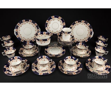 A Melba china part tea service, pattern no. 2836, cobalt blue borders with interspersed floral reserves and gilt highlights &