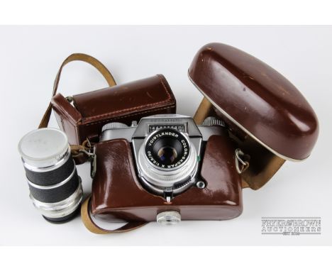 A Voigtlander Bessamatic 35mm Colour-Skopar X 1:2:8/50 camera, with leather case; and a Super-Dynarex 1:4/135 lens, cased