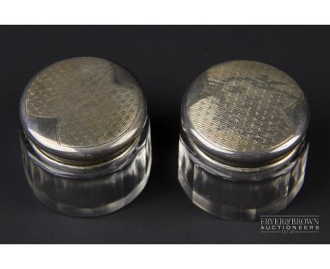 A pair of cut glass rouge pots, the silver lids with gilt interiors and engine turned decoration top top, makers mark B &amp;