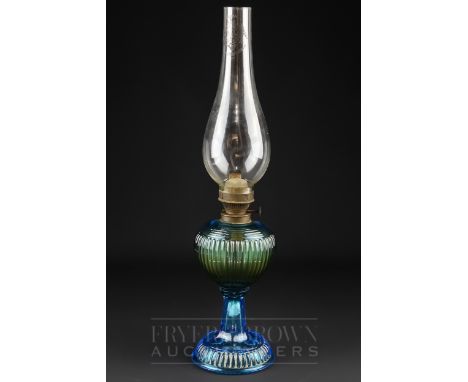 A blue moulded glass oil lamp, the clear glass chimney marked 'Cristal' and 'S &amp; N Lucifer', 44cm high max.