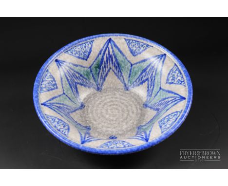 A Pilkingtons Royal Lancastrian pottery bowl, circular with crested rim, decorated with a large star motif in blue and green,
