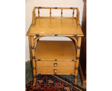 A faux bamboo bedside cabinet with one shelf above two drawers