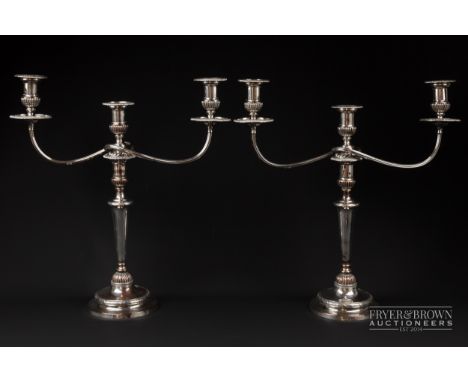 A pair of Sheffield plate three light candelabra, on reeded vase columns, 48.5cm high
