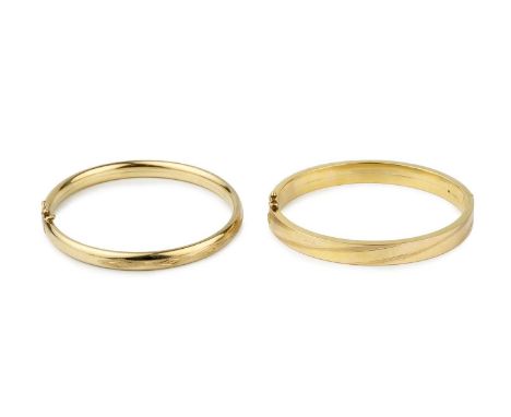 A 9ct gold oval hinged bangle, with line engraved decoration, clasp stamped 375, 6.8cm wide, and an Italian 9k gold bangle. (