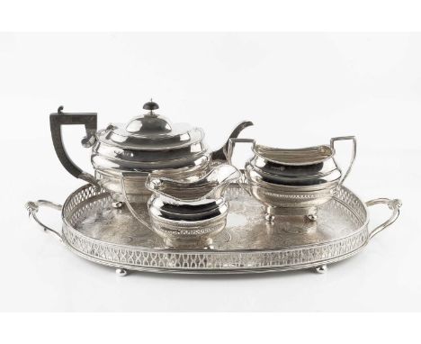 An Edwardian silver three piece tea service, with gadrooned borders, the teapot with ebonised handle by William Henry Sparrow