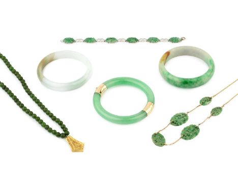 A 14k gold mounted jade hinged bangle, 7.6cm wide, two further pale mottled jade bangles, a 9ct gold fine trace link necklace