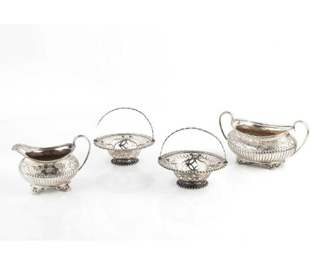 A late Victorian silver twin handled sucrier, and matching milk jug, with lobed and foliate embossed decoration, on shaped fe